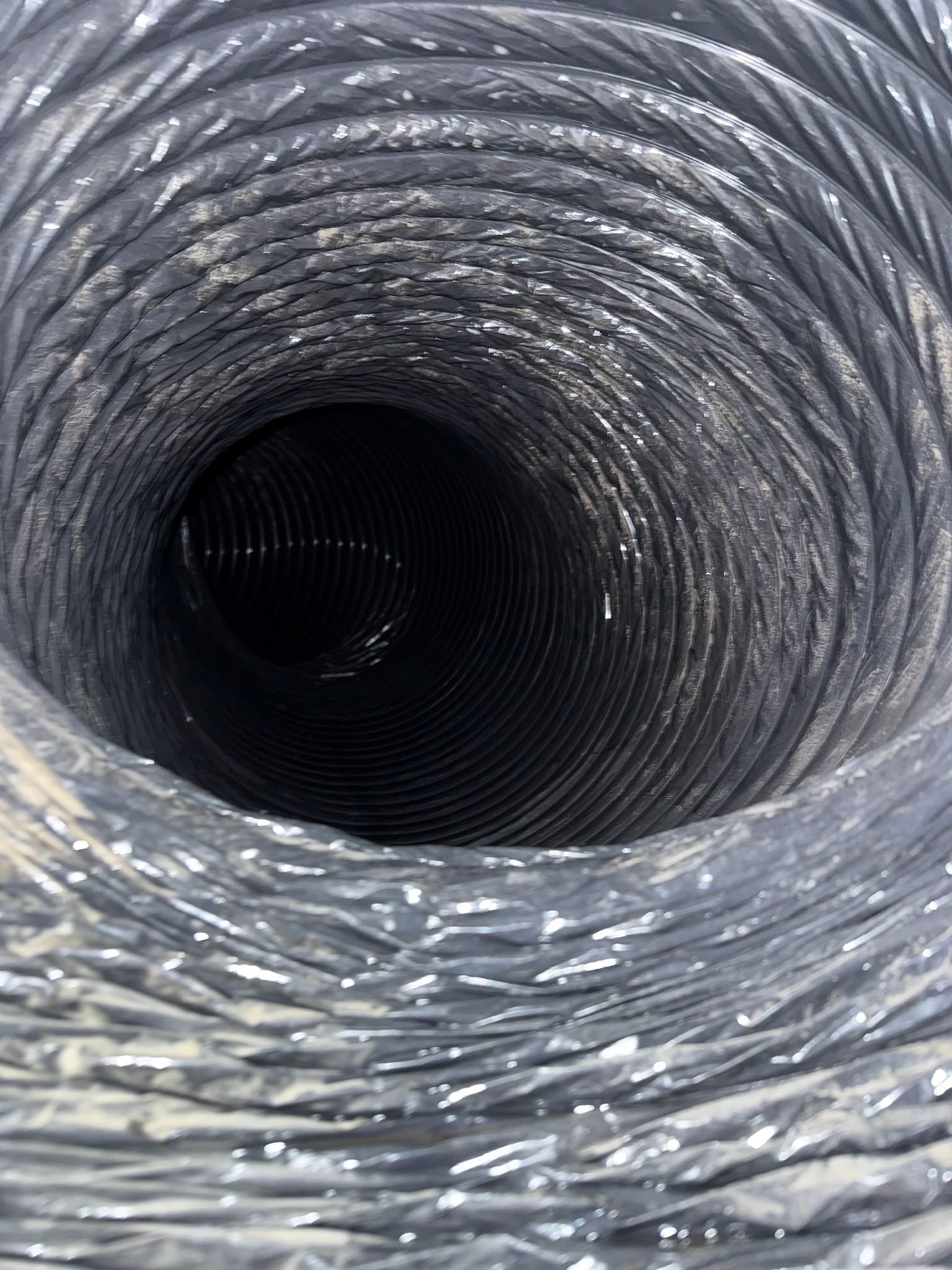 Inside view of a residential air duct before professional air duct cleaning in Indiana