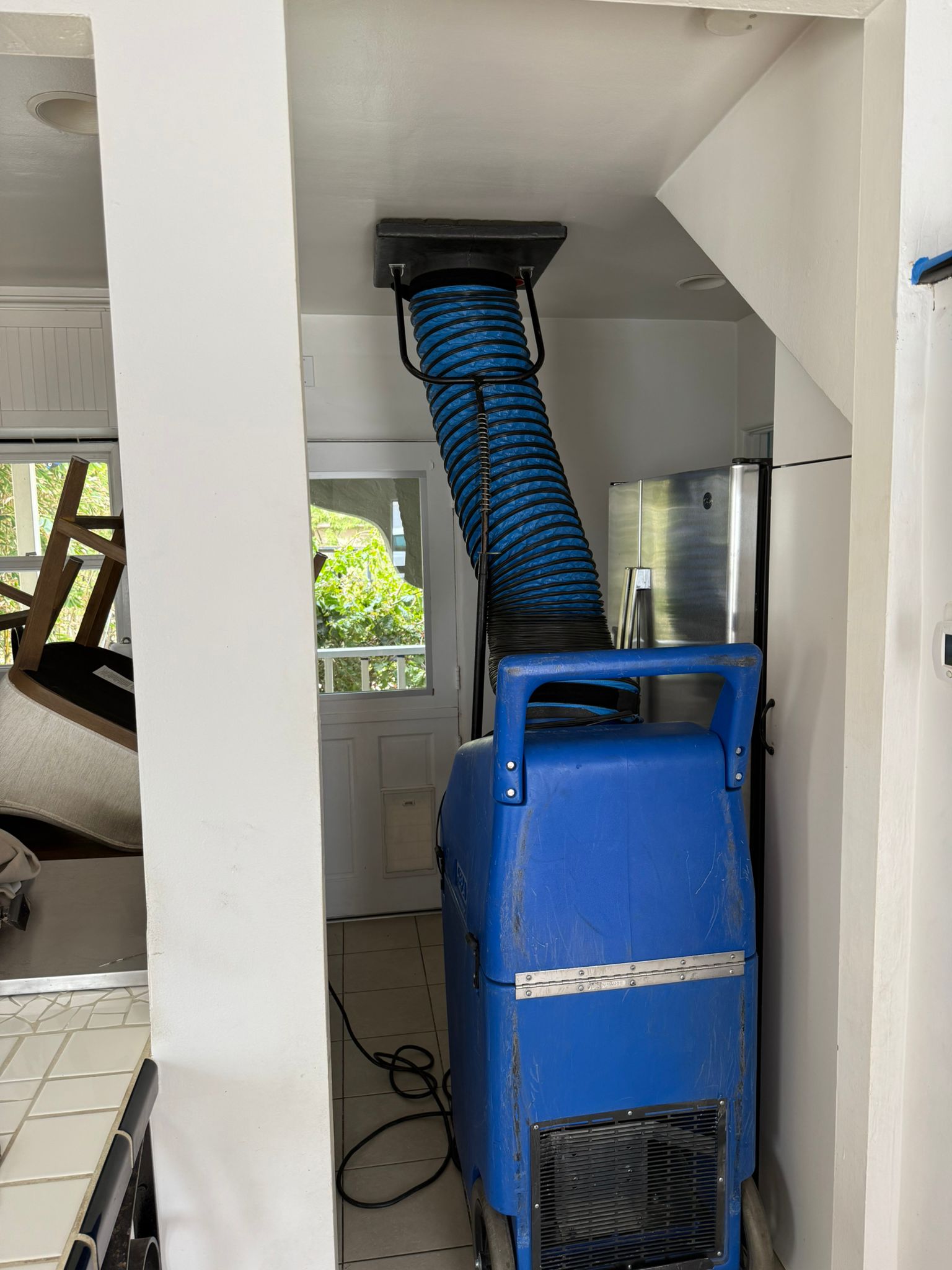 Negative air machine connected to HVAC system during professional air duct cleaning in Indiana home